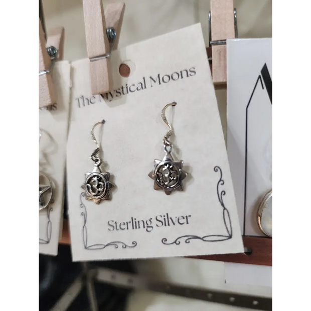 Sterling silver earrings featuring a radiant sun with the Om symbol at the center, displayed on a white background. Perfect for spiritual radiance, peace, and sacred style.