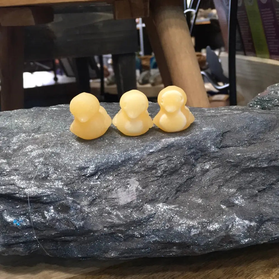 Hand-carved orange calcite mini duck with vibrant orange hues, displayed on a white background. Perfect for joy, playfulness, and creative energy.