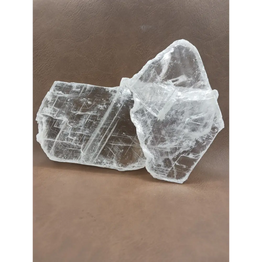 Pink selenite slab, polished with soft rosy hues, displayed on a white background.