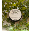 Poison Ivy Salve in a small jar, surrounded by fresh green leaves, displayed on a white background. Perfect for soothing and healing skin irritated by poison ivy, oak, or sumac.

