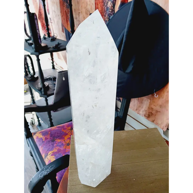 Diamantina clear quartz tower, 17 inches tall, polished with exceptional clarity and natural inclusions, displayed on a white background.