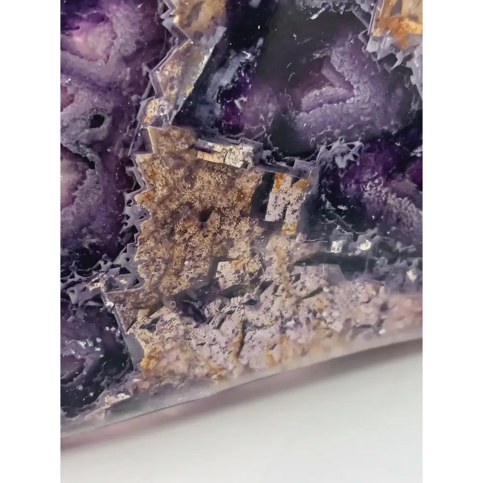 Rainbow fluorite bowl, 7.5 inches, with vibrant bands of color and a garden-like pattern on the back, displayed on a white background.