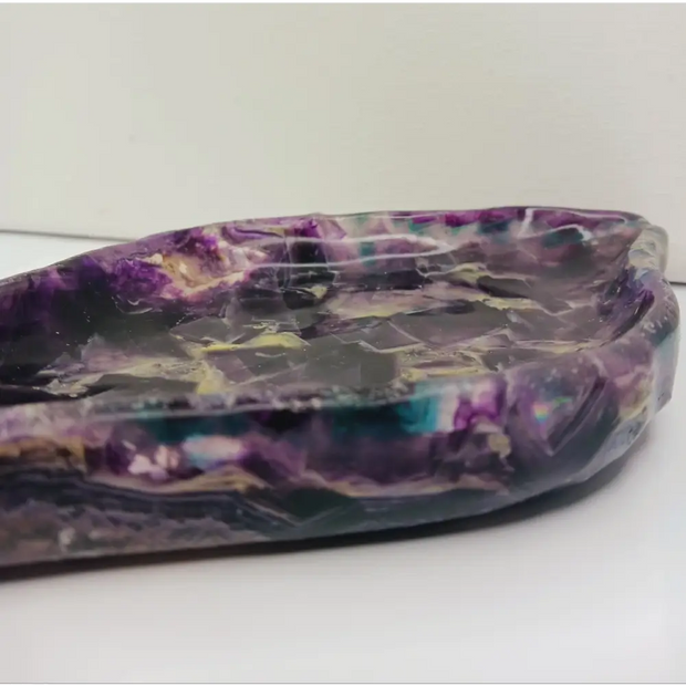 Rainbow fluorite bowl, 7.5 inches, with vibrant bands of color and a garden-like pattern on the back, displayed on a white background.