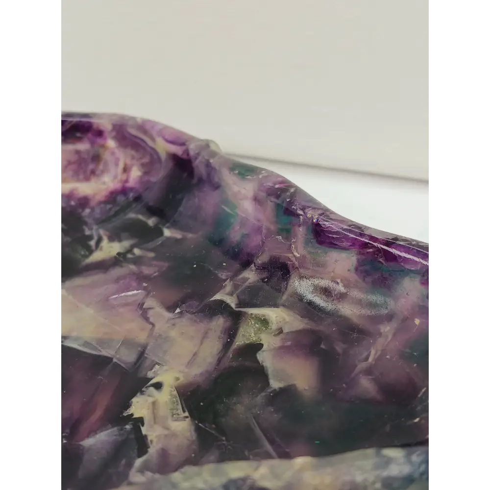 Rainbow fluorite bowl, 7.5 inches, with vibrant bands of color and a garden-like pattern on the back, displayed on a white background.
