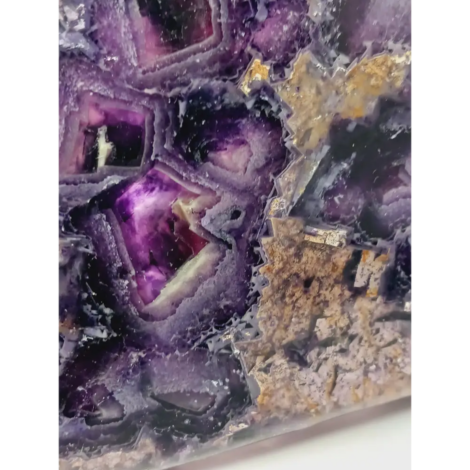 Rainbow fluorite bowl, 7.5 inches, with vibrant bands of color and a garden-like pattern on the back, displayed on a white background.