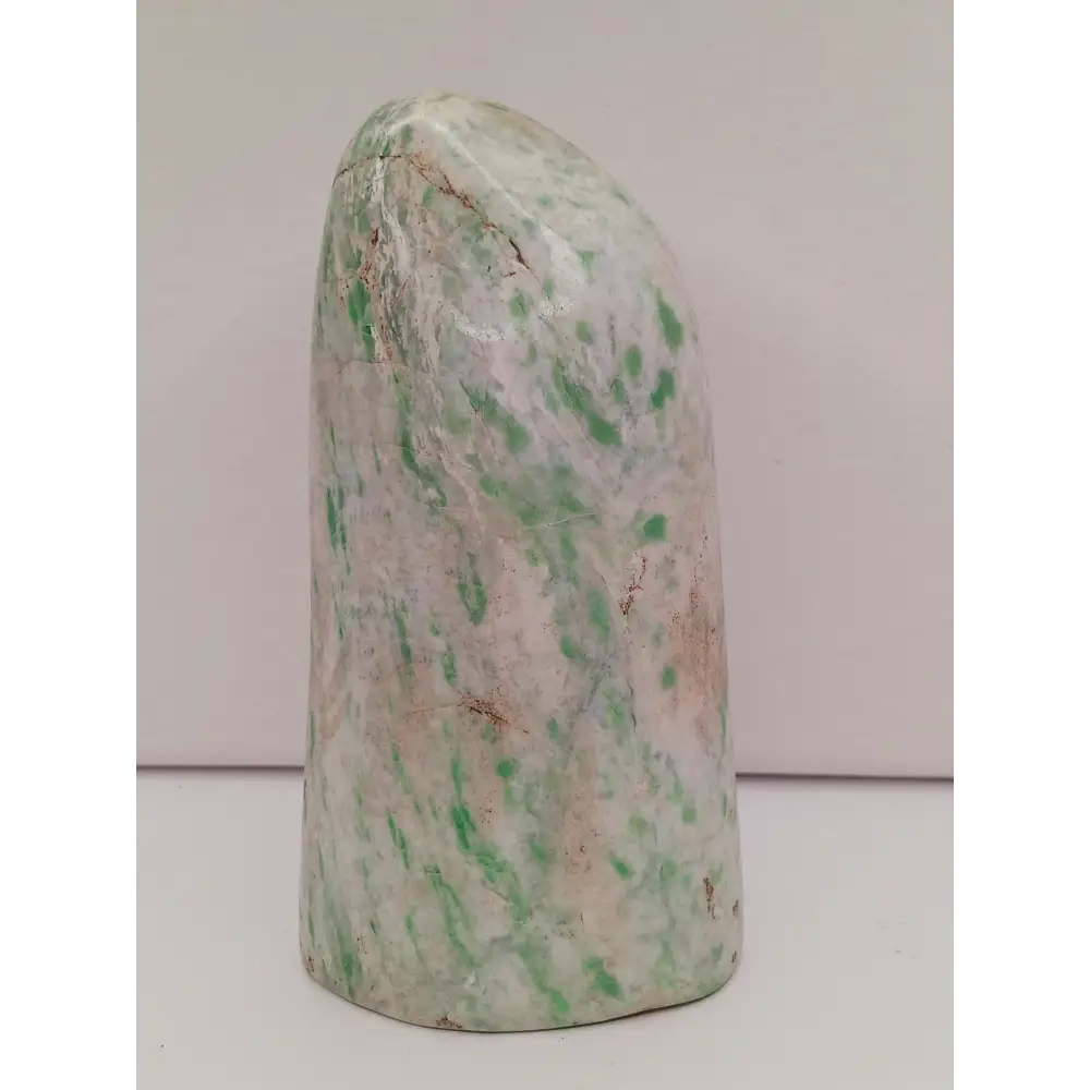 Sausserite freeform with soothing green hues and a unique, polished shape, displayed on a white background.