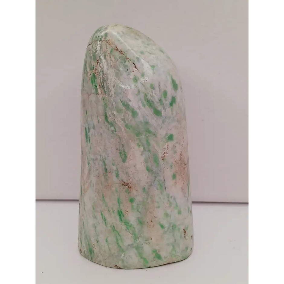 Sausserite freeform with soothing green hues and a unique, polished shape, displayed on a white background.