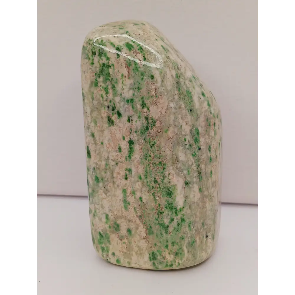 Sausserite freeform with soothing green hues and a unique, polished shape, displayed on a white background.