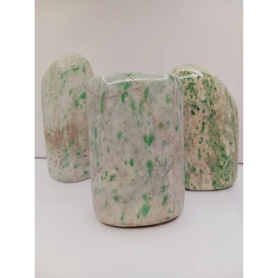 Sausserite freeform with soothing green hues and a unique, polished shape, displayed on a white background.