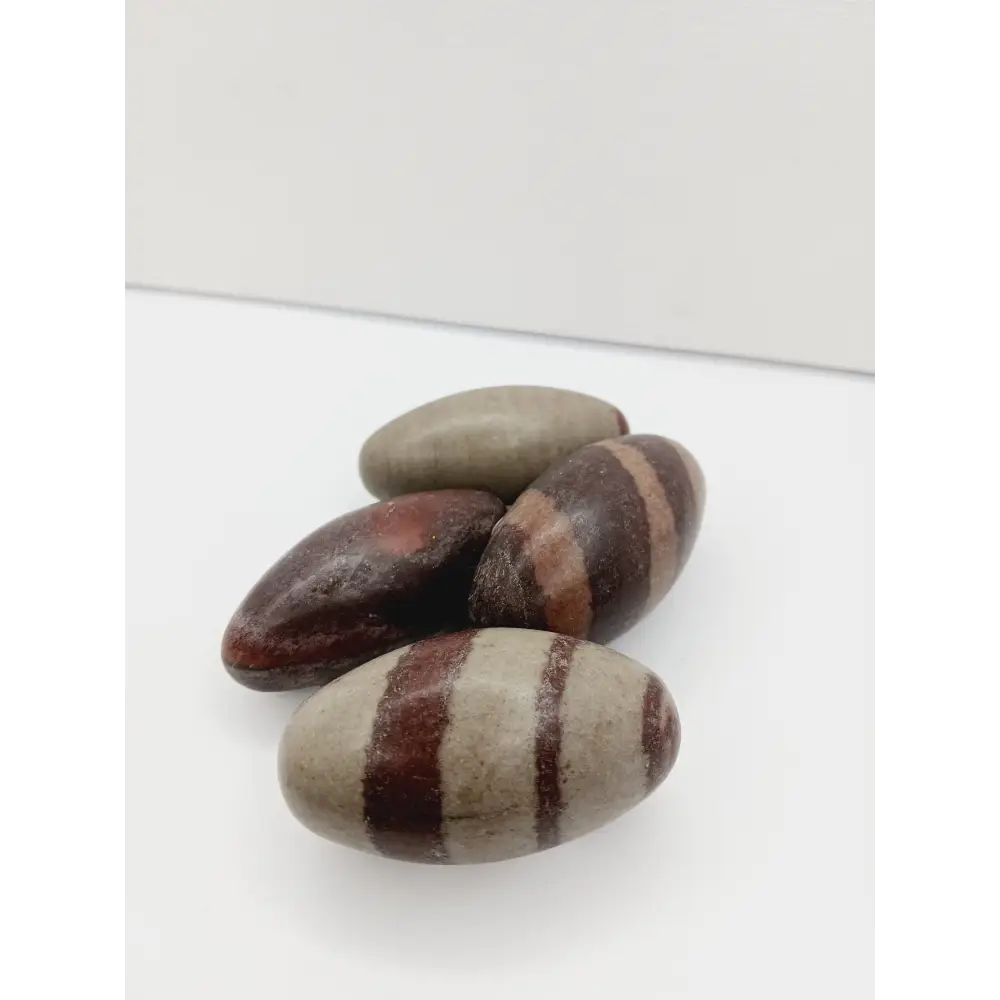 Shiva Lingam stones, polished with natural earthy patterns, available in sizes 1