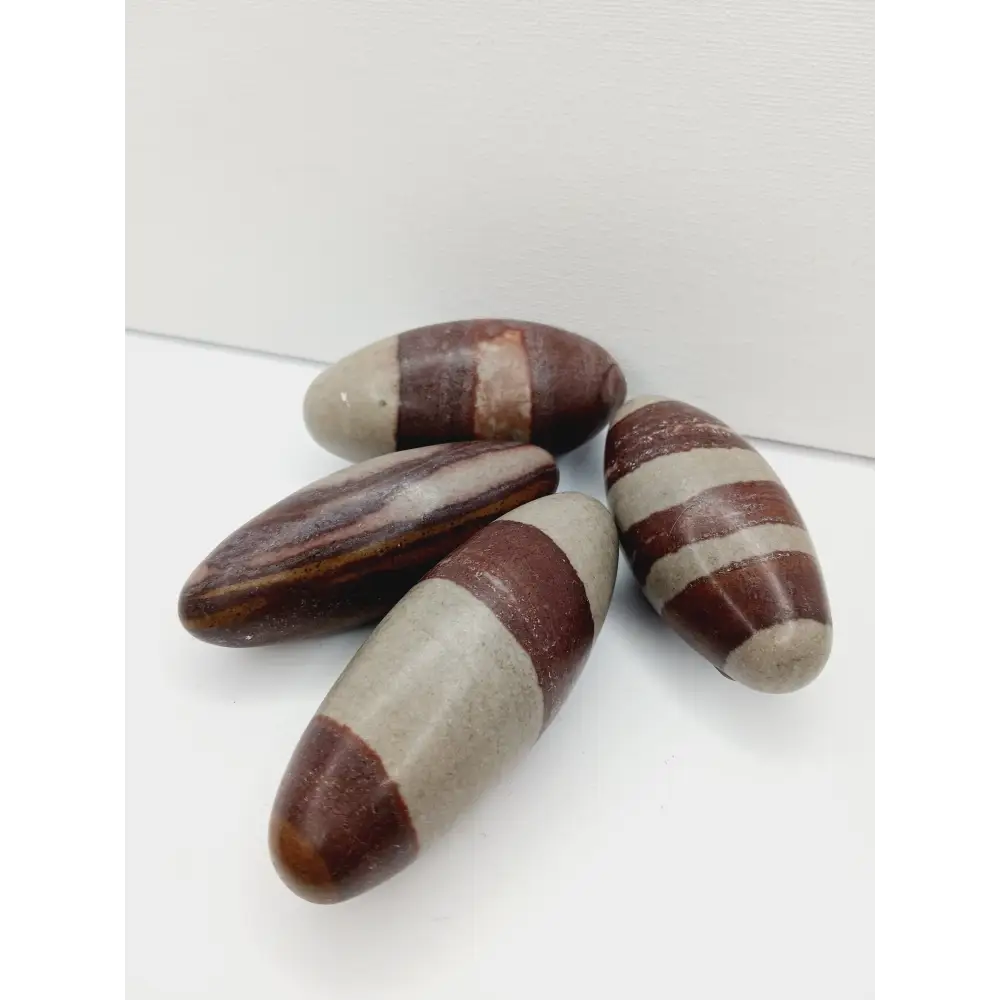Shiva Lingam stones, polished with natural earthy patterns, available in sizes 1