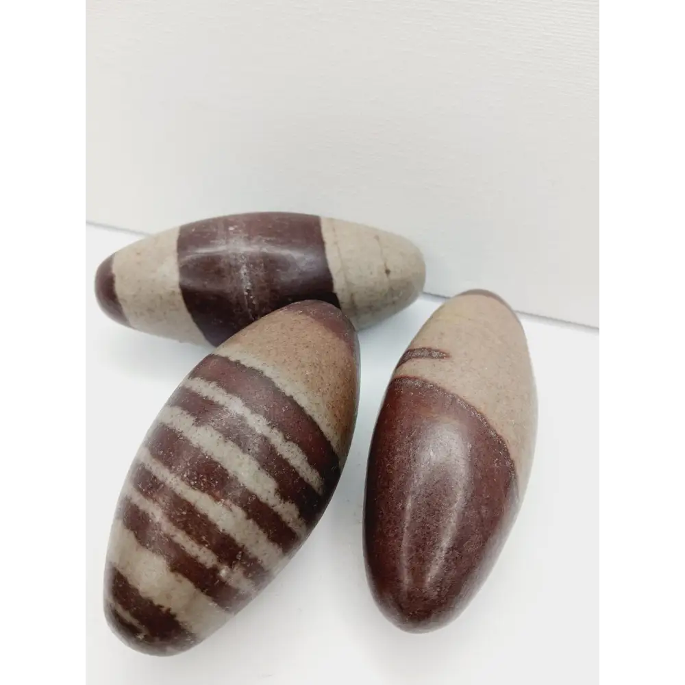 Shiva Lingam stones, polished with natural earthy patterns, available in sizes 1