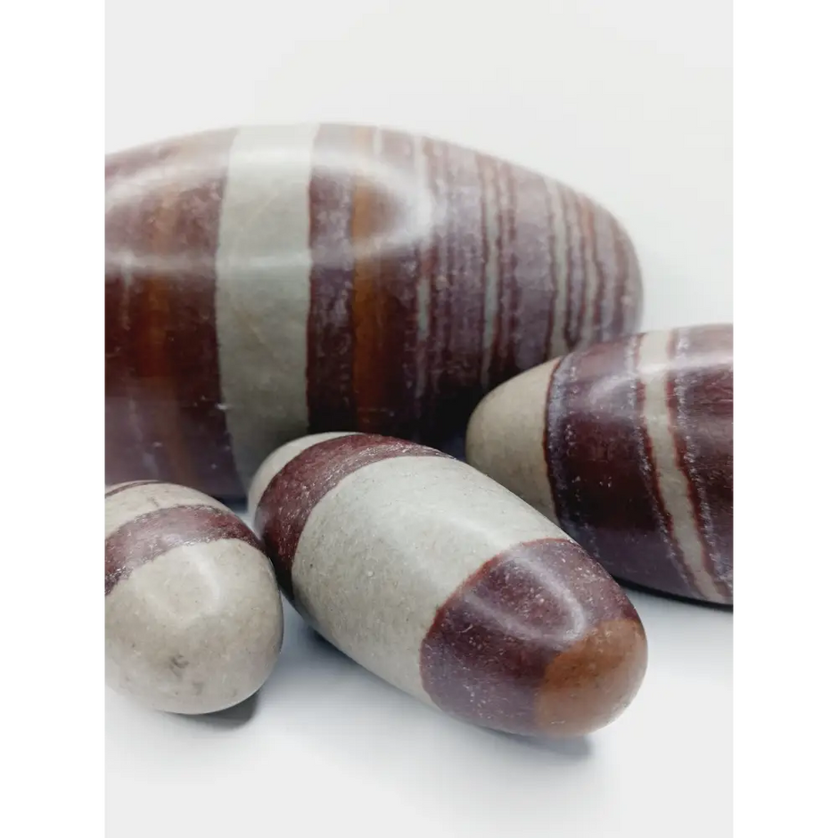 Shiva Lingam stones, polished with natural earthy patterns, available in sizes 1