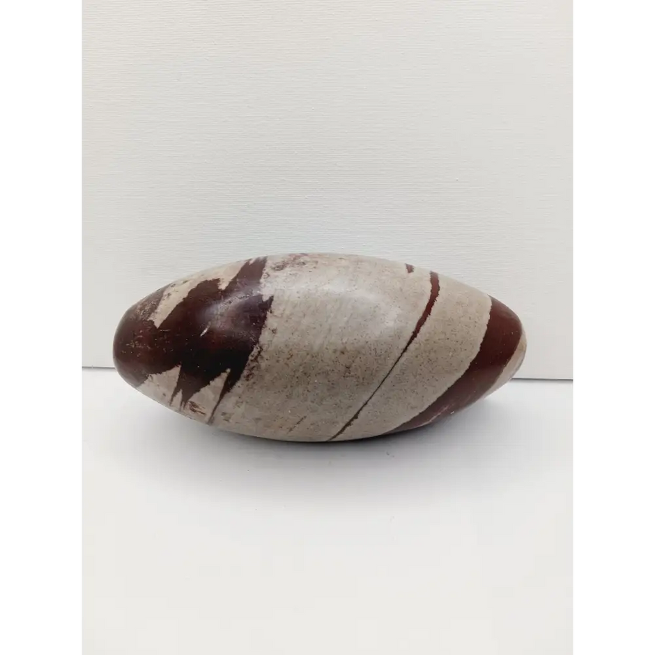 Shiva Lingam stones, polished with natural earthy patterns, available in sizes 1