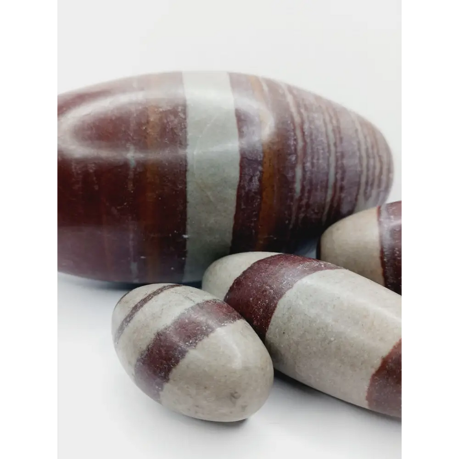 Shiva Lingam stones, polished with natural earthy patterns, available in sizes 1