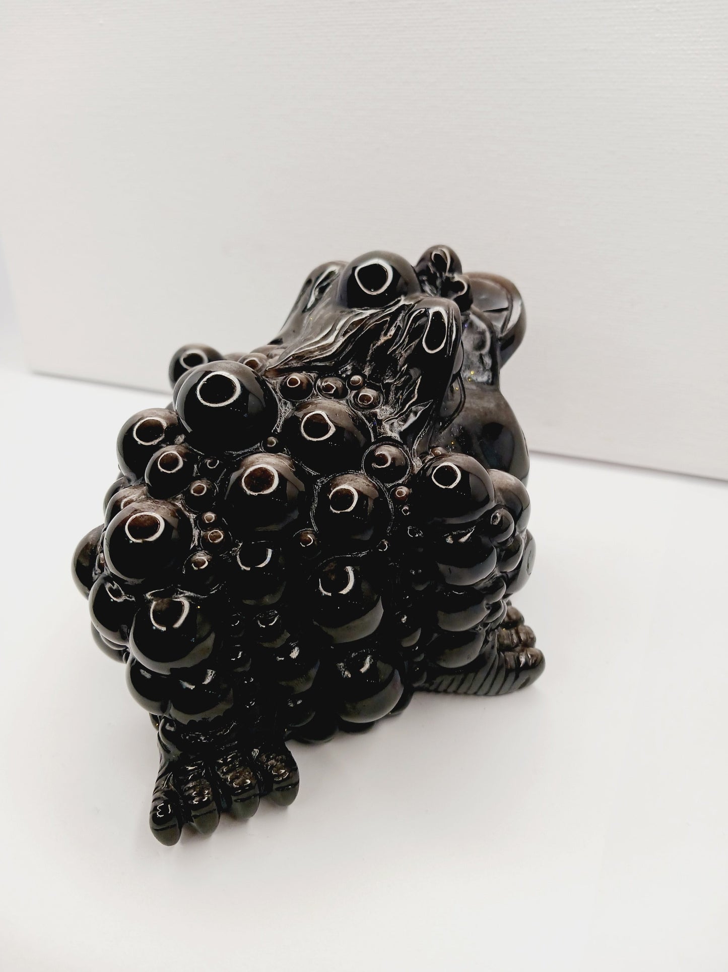 Silver sheen obsidian money toad, hand-carved with a reflective silver luster, measuring 5.5 inches, displayed on a white background.