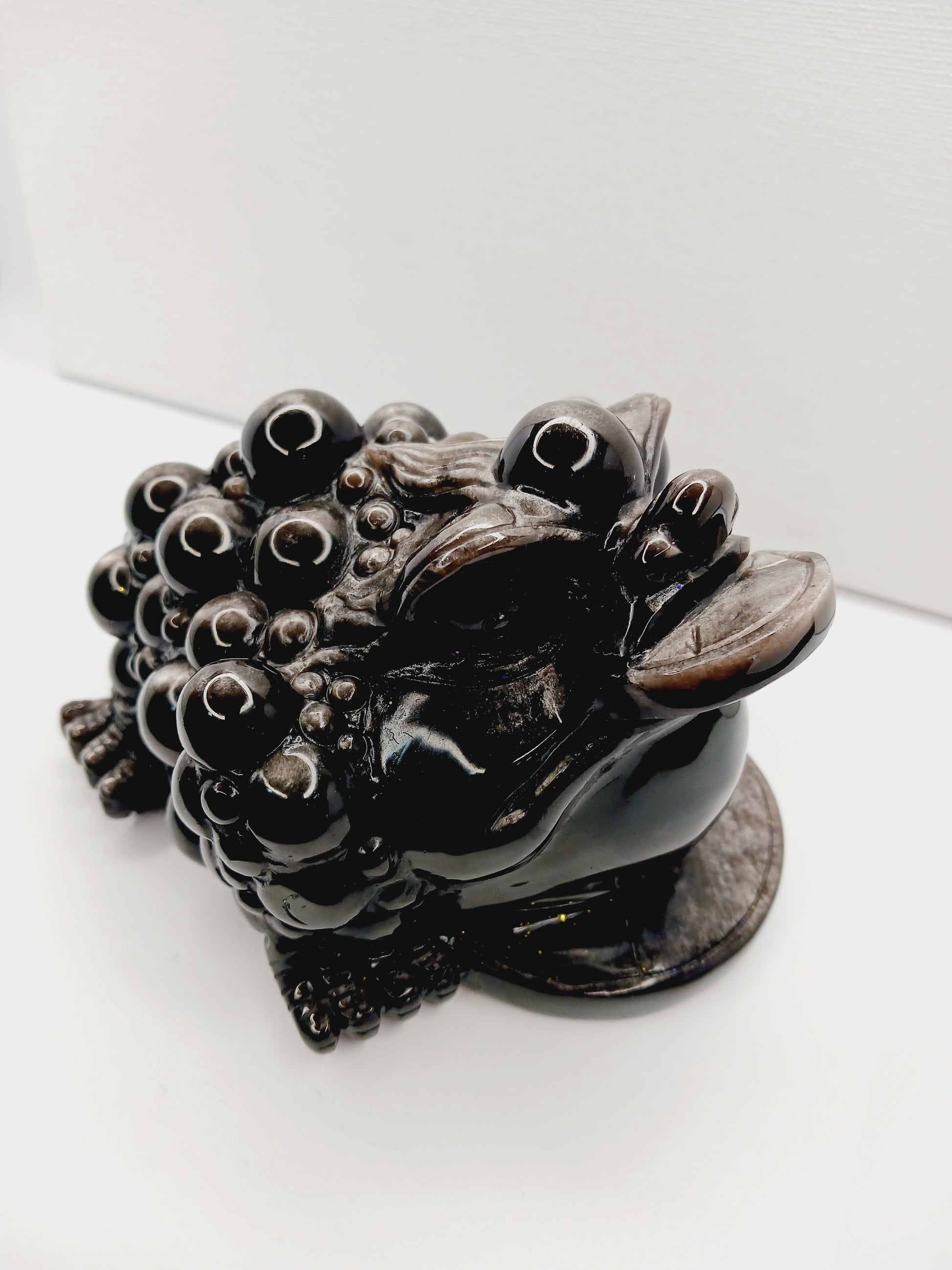 Silver sheen obsidian money toad, hand-carved with a reflective silver luster, measuring 5.5 inches, displayed on a white background.