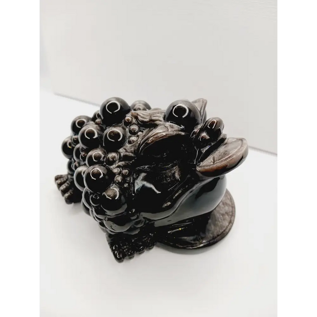 Silver sheen obsidian money toad, hand-carved with a reflective silver luster, measuring 5.5 inches, displayed on a white background.