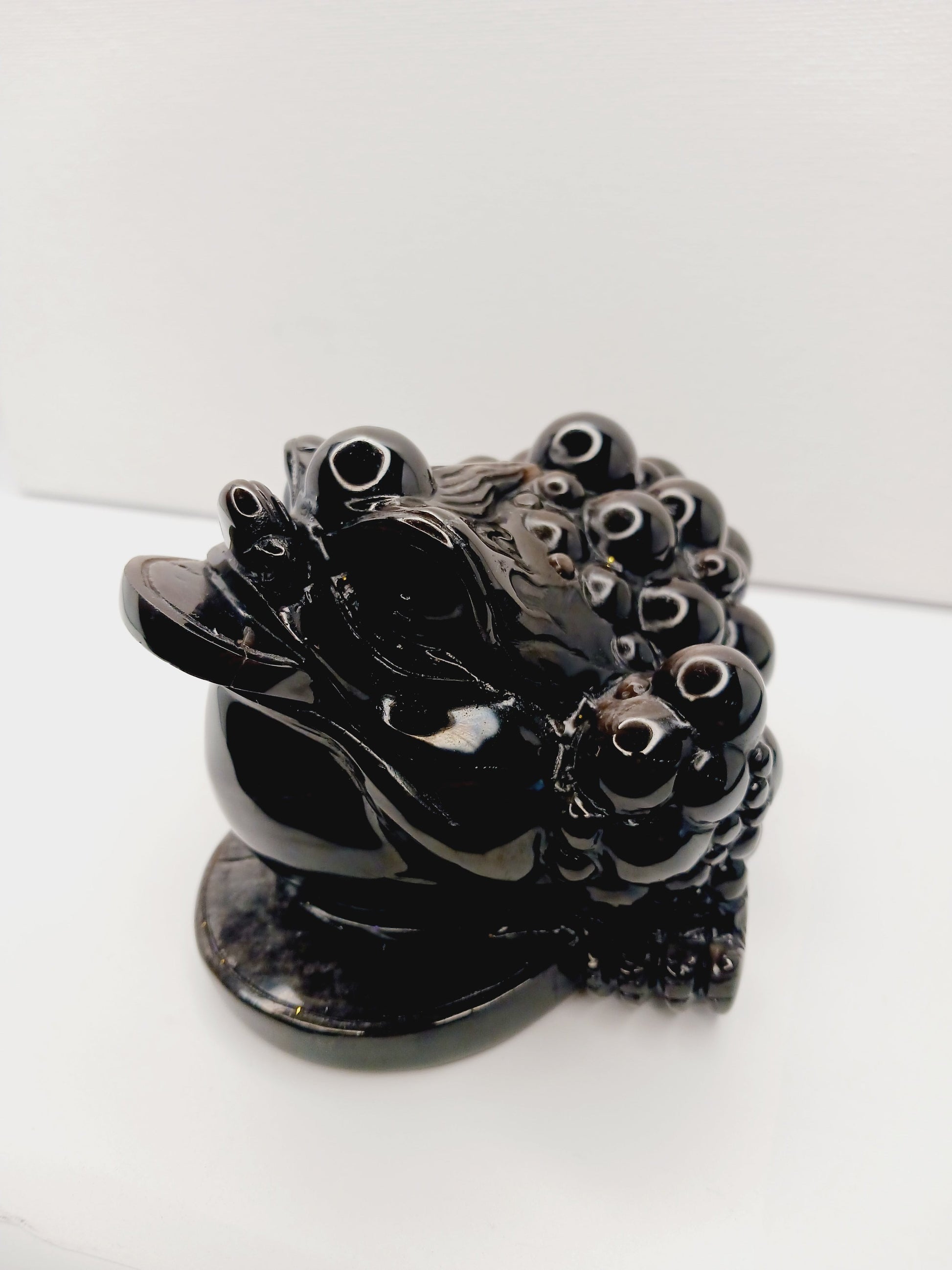 Silver sheen obsidian money toad, hand-carved with a reflective silver luster, measuring 5.5 inches, displayed on a white background.