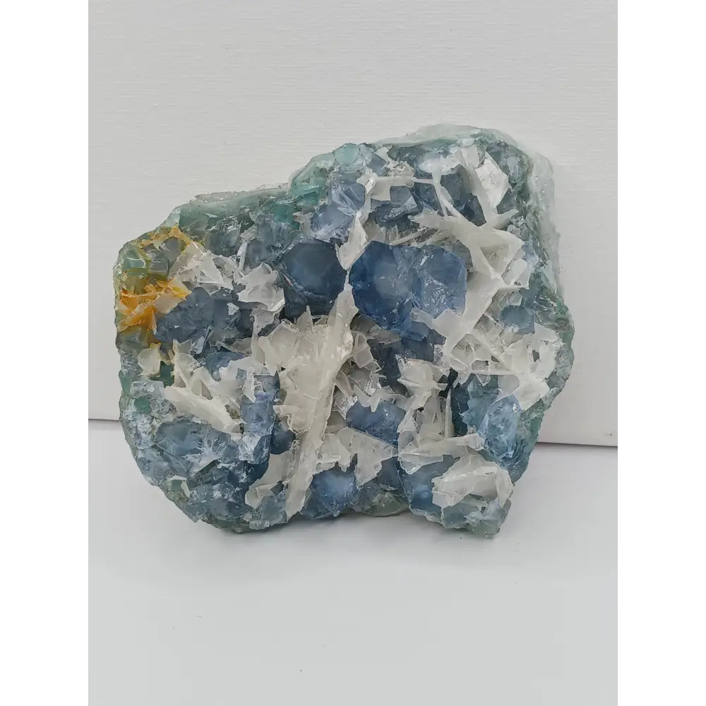 Sky blue fluorite with creamy calcite specimen, 4 x 5 inches, featuring unique blue and white patterns, displayed on a white background.