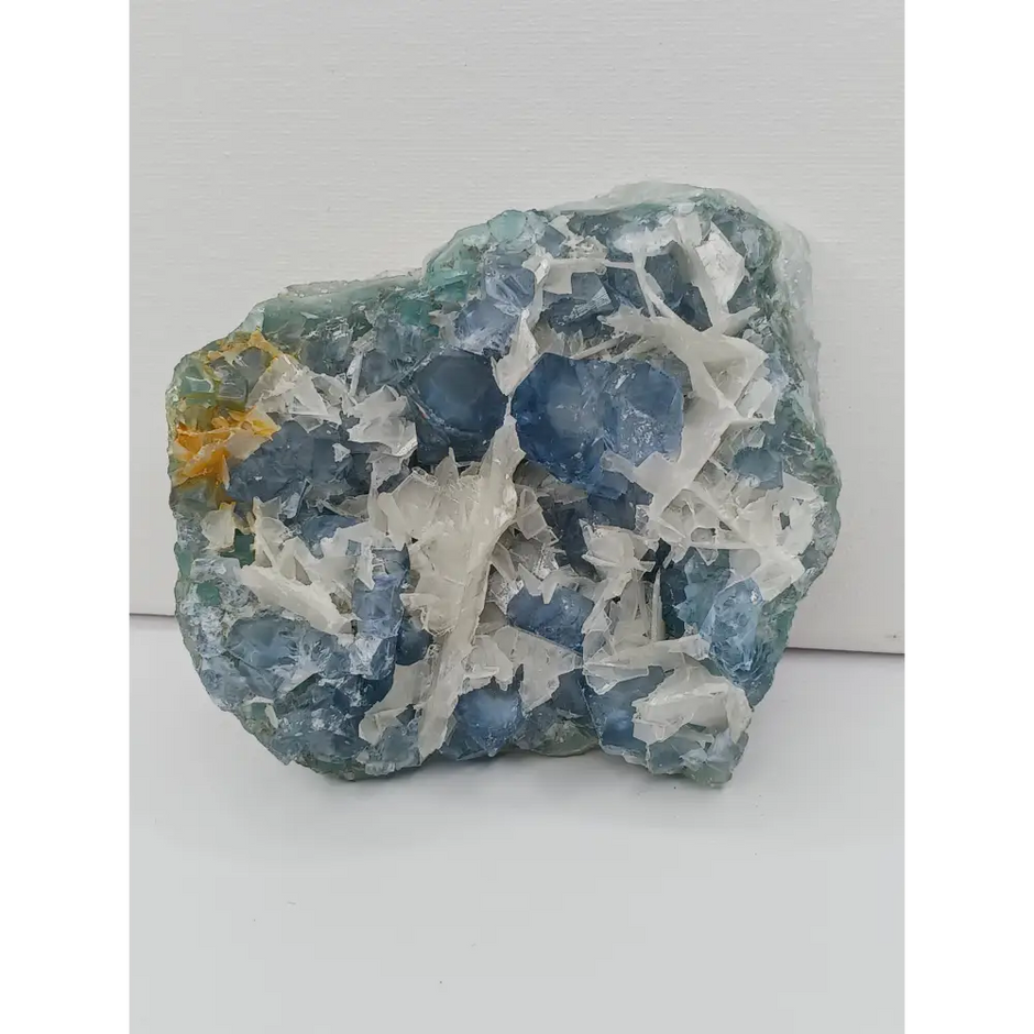Sky blue fluorite with creamy calcite specimen, 4 x 5 inches, featuring unique blue and white patterns, displayed on a white background.