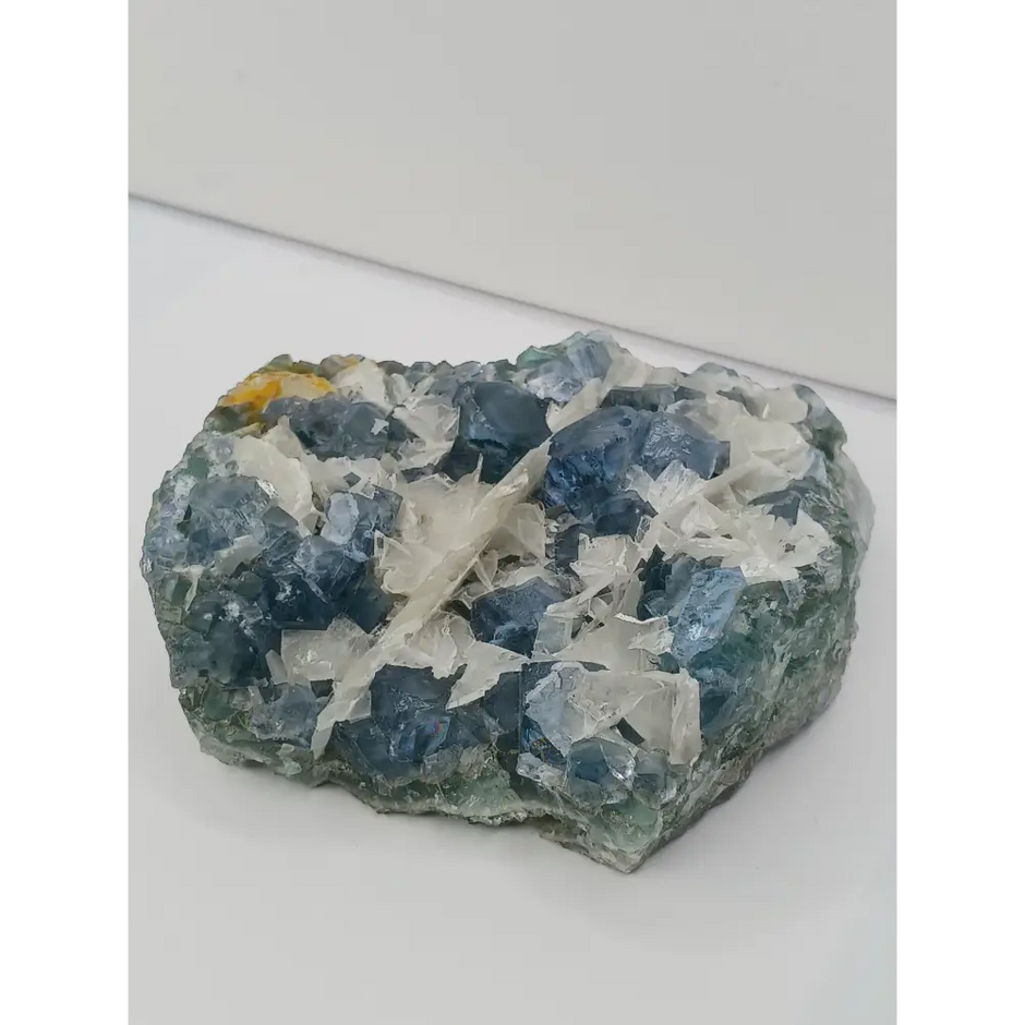 Sky blue fluorite with creamy calcite specimen, 4 x 5 inches, featuring unique blue and white patterns, displayed on a white background.