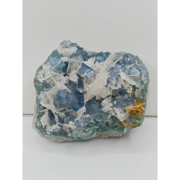 Sky blue fluorite with creamy calcite specimen, 4 x 5 inches, featuring unique blue and white patterns, displayed on a white background.