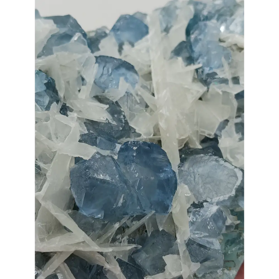 Sky blue fluorite with creamy calcite specimen, 4 x 5 inches, featuring unique blue and white patterns, displayed on a white background.