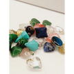 Assorted small stone pendants, each with polished gemstones in various colors and shapes, displayed on a white background.