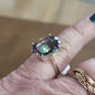 Assorted sterling silver rings featuring unique genuine gemstones in various shapes and colors, displayed on a white background. Perfect for crystal energy, personal style, and one-of-a-kind magic.
