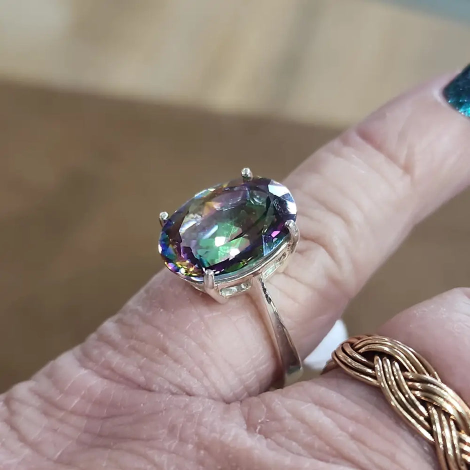 Assorted sterling silver rings featuring unique genuine gemstones in various shapes and colors, displayed on a white background. Perfect for crystal energy, personal style, and one-of-a-kind magic.