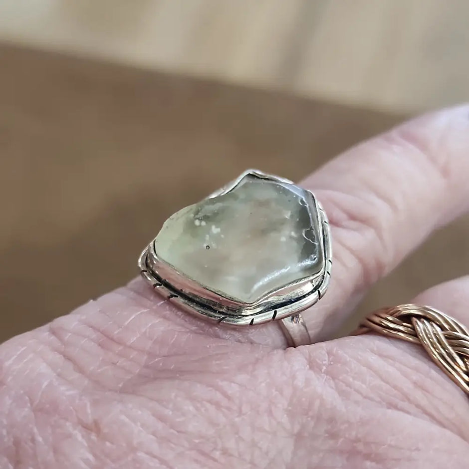 Assorted sterling silver rings featuring unique genuine gemstones in various shapes and colors, displayed on a white background. Perfect for crystal energy, personal style, and one-of-a-kind magic.