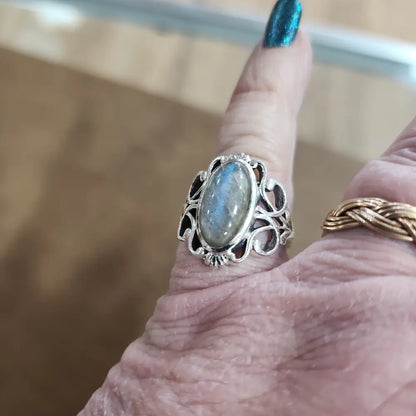 Assorted sterling silver rings featuring unique genuine gemstones in various shapes and colors, displayed on a white background. Perfect for crystal energy, personal style, and one-of-a-kind magic.