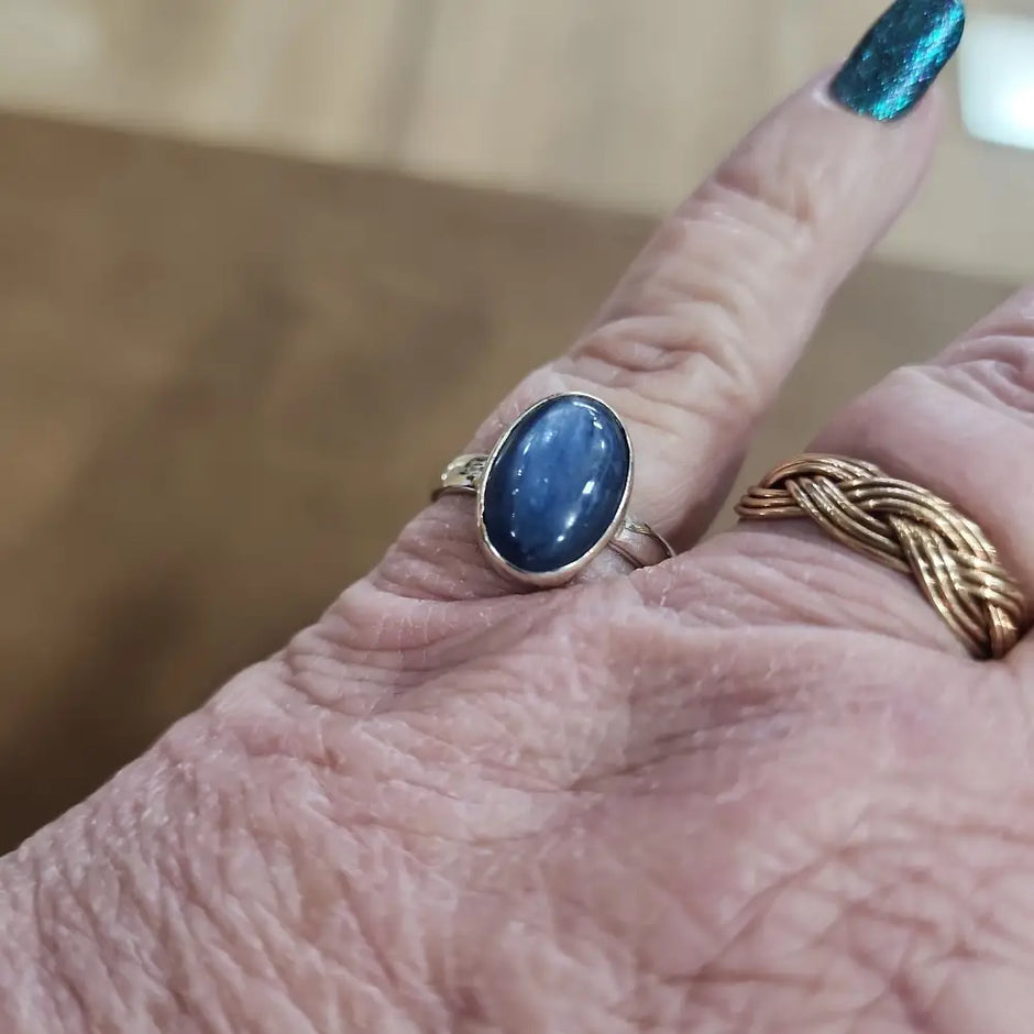Assorted sterling silver rings featuring unique genuine gemstones in various shapes and colors, displayed on a white background. Perfect for crystal energy, personal style, and one-of-a-kind magic.