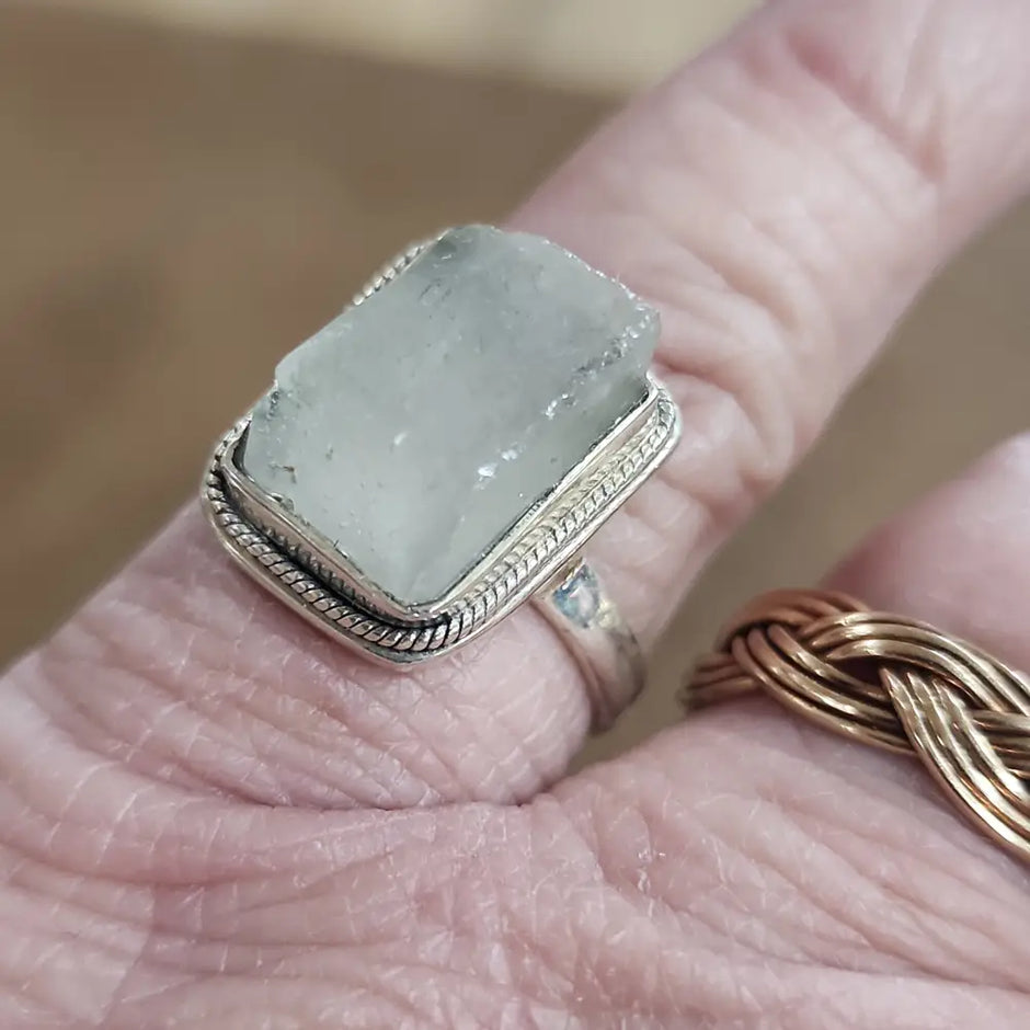 Assorted sterling silver rings featuring unique genuine gemstones in various shapes and colors, displayed on a white background. Perfect for crystal energy, personal style, and one-of-a-kind magic.