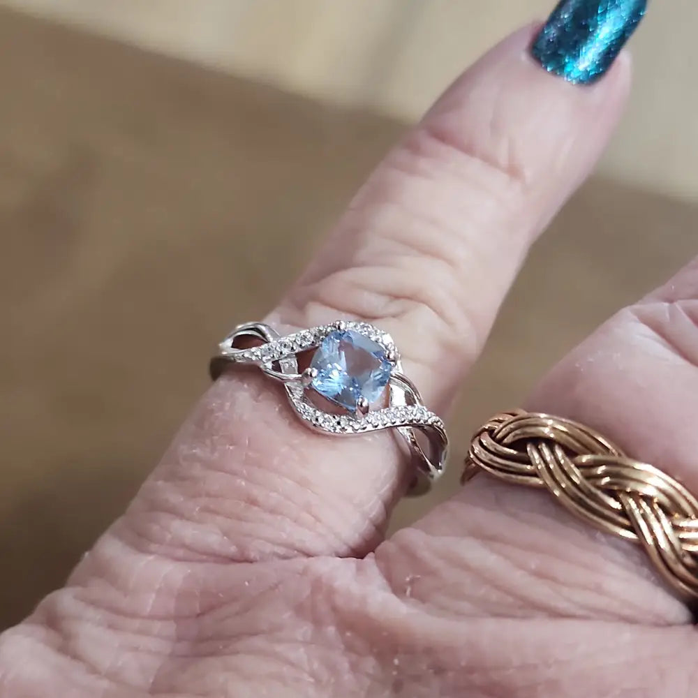 Assorted sterling silver rings featuring unique genuine gemstones in various shapes and colors, displayed on a white background. Perfect for crystal energy, personal style, and one-of-a-kind magic.