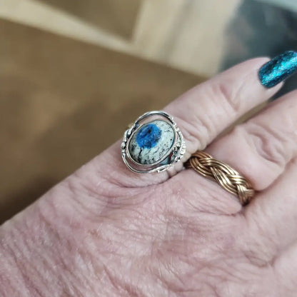 Assorted sterling silver rings featuring unique genuine gemstones in various shapes and colors, displayed on a white background. Perfect for crystal energy, personal style, and one-of-a-kind magic.