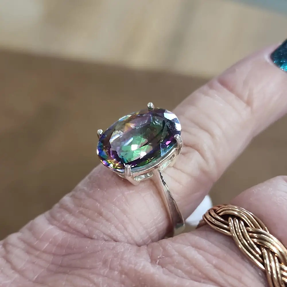 Assorted sterling silver rings featuring unique genuine gemstones in various shapes and colors, displayed on a white background. Perfect for crystal energy, personal style, and one-of-a-kind magic.