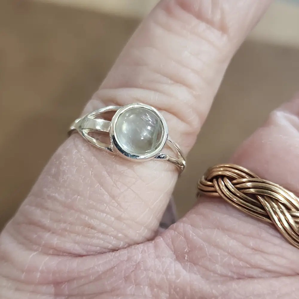 Assorted sterling silver rings featuring unique genuine gemstones in various shapes and colors, displayed on a white background. Perfect for crystal energy, personal style, and one-of-a-kind magic.