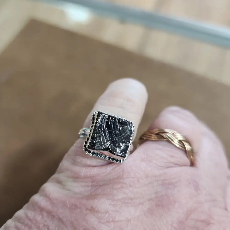 Assorted sterling silver rings featuring unique genuine gemstones in various shapes and colors, displayed on a white background. Perfect for crystal energy, personal style, and one-of-a-kind magic.