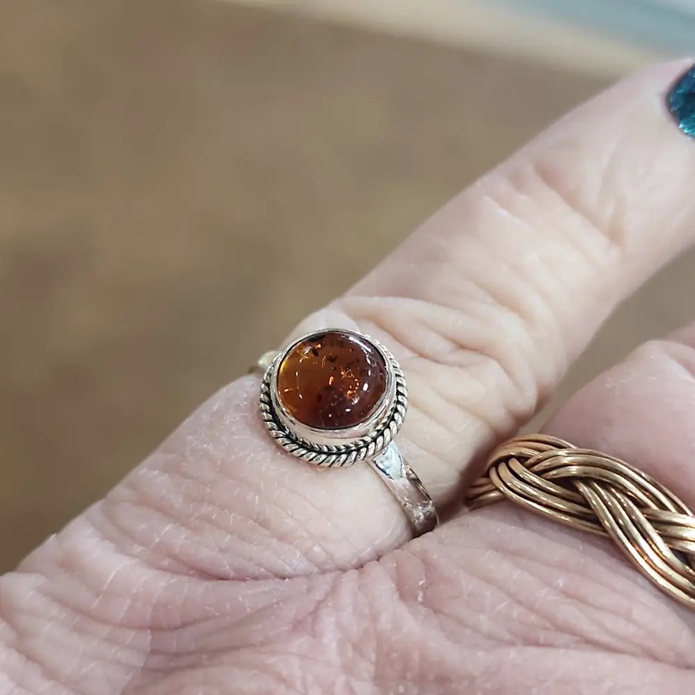 Assorted sterling silver rings featuring unique genuine gemstones in various shapes and colors, displayed on a white background. Perfect for crystal energy, personal style, and one-of-a-kind magic.