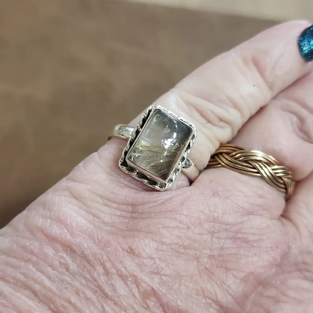 Assorted sterling silver rings featuring unique genuine gemstones in various shapes and colors, displayed on a white background. Perfect for crystal energy, personal style, and one-of-a-kind magic.