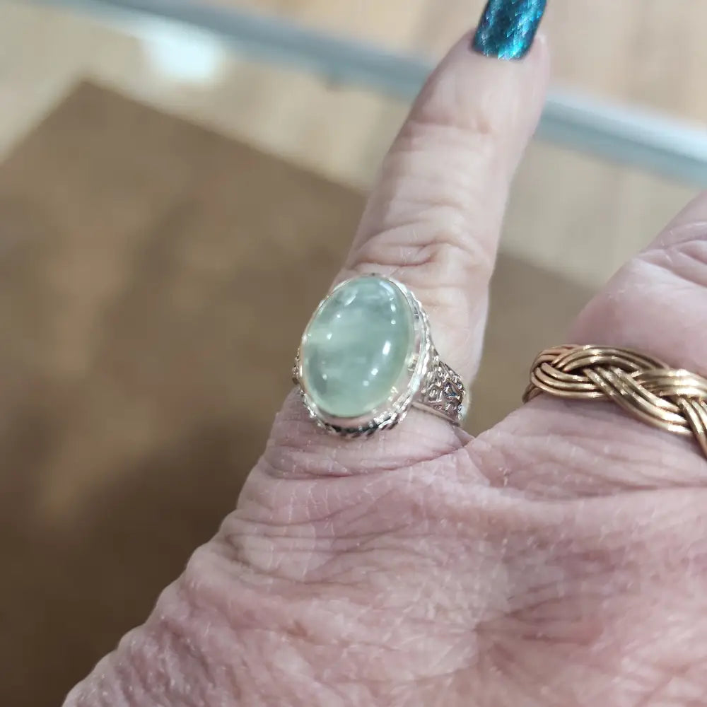 Assorted sterling silver rings featuring unique genuine gemstones in various shapes and colors, displayed on a white background. Perfect for crystal energy, personal style, and one-of-a-kind magic.