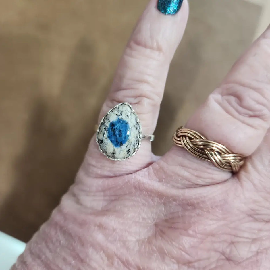 Assorted sterling silver rings featuring unique genuine gemstones in various shapes and colors, displayed on a white background. Perfect for crystal energy, personal style, and one-of-a-kind magic.