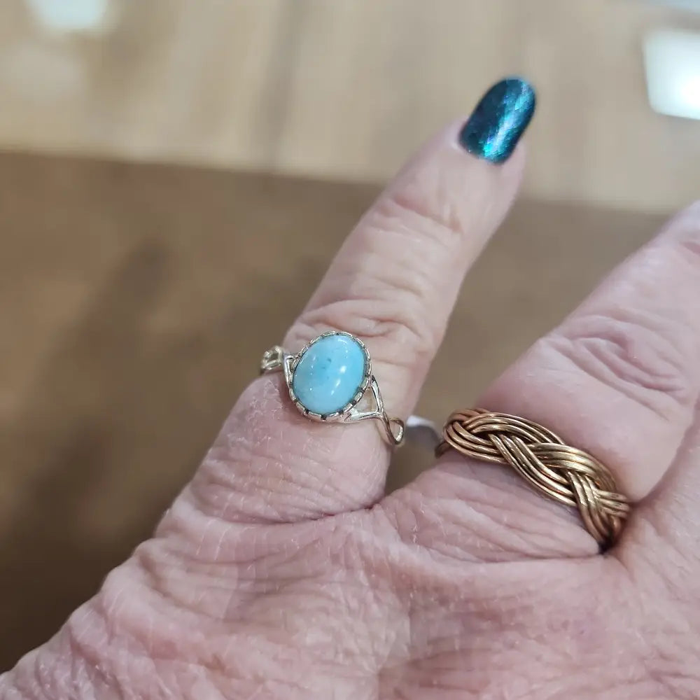 Assorted sterling silver rings featuring unique genuine gemstones in various shapes and colors, displayed on a white background. Perfect for crystal energy, personal style, and one-of-a-kind magic.