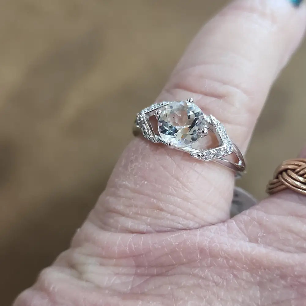 Assorted sterling silver rings featuring unique genuine gemstones in various shapes and colors, displayed on a white background. Perfect for crystal energy, personal style, and one-of-a-kind magic.