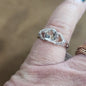 Assorted sterling silver rings featuring unique genuine gemstones in various shapes and colors, displayed on a white background. Perfect for crystal energy, personal style, and one-of-a-kind magic.