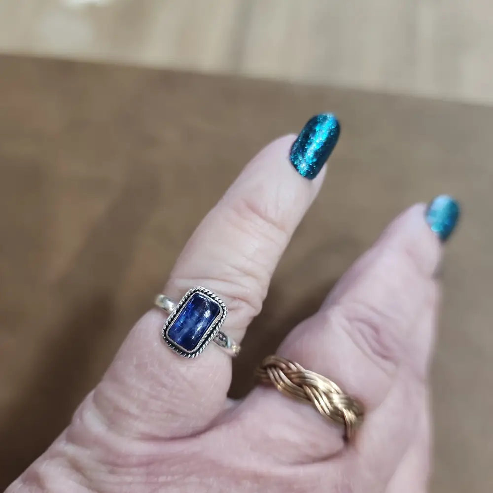 Assorted sterling silver rings featuring unique genuine gemstones in various shapes and colors, displayed on a white background. Perfect for crystal energy, personal style, and one-of-a-kind magic.