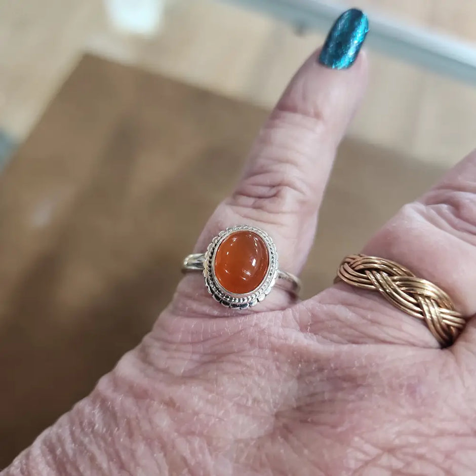 Assorted sterling silver rings featuring unique genuine gemstones in various shapes and colors, displayed on a white background. Perfect for crystal energy, personal style, and one-of-a-kind magic.
