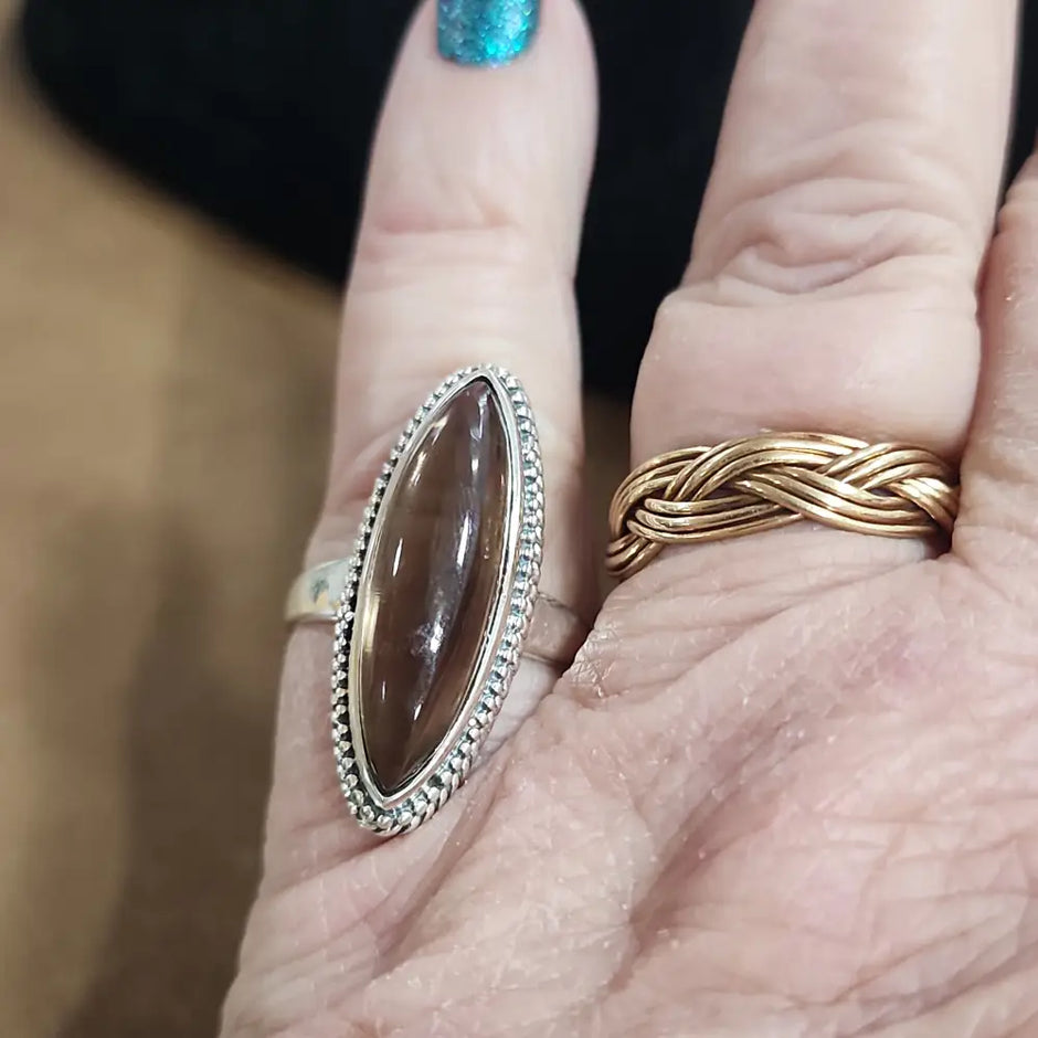 Assorted sterling silver rings featuring unique genuine gemstones in various shapes and colors, displayed on a white background. Perfect for crystal energy, personal style, and one-of-a-kind magic.